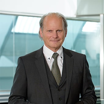 Covid expert dressed in a suit standing in lab